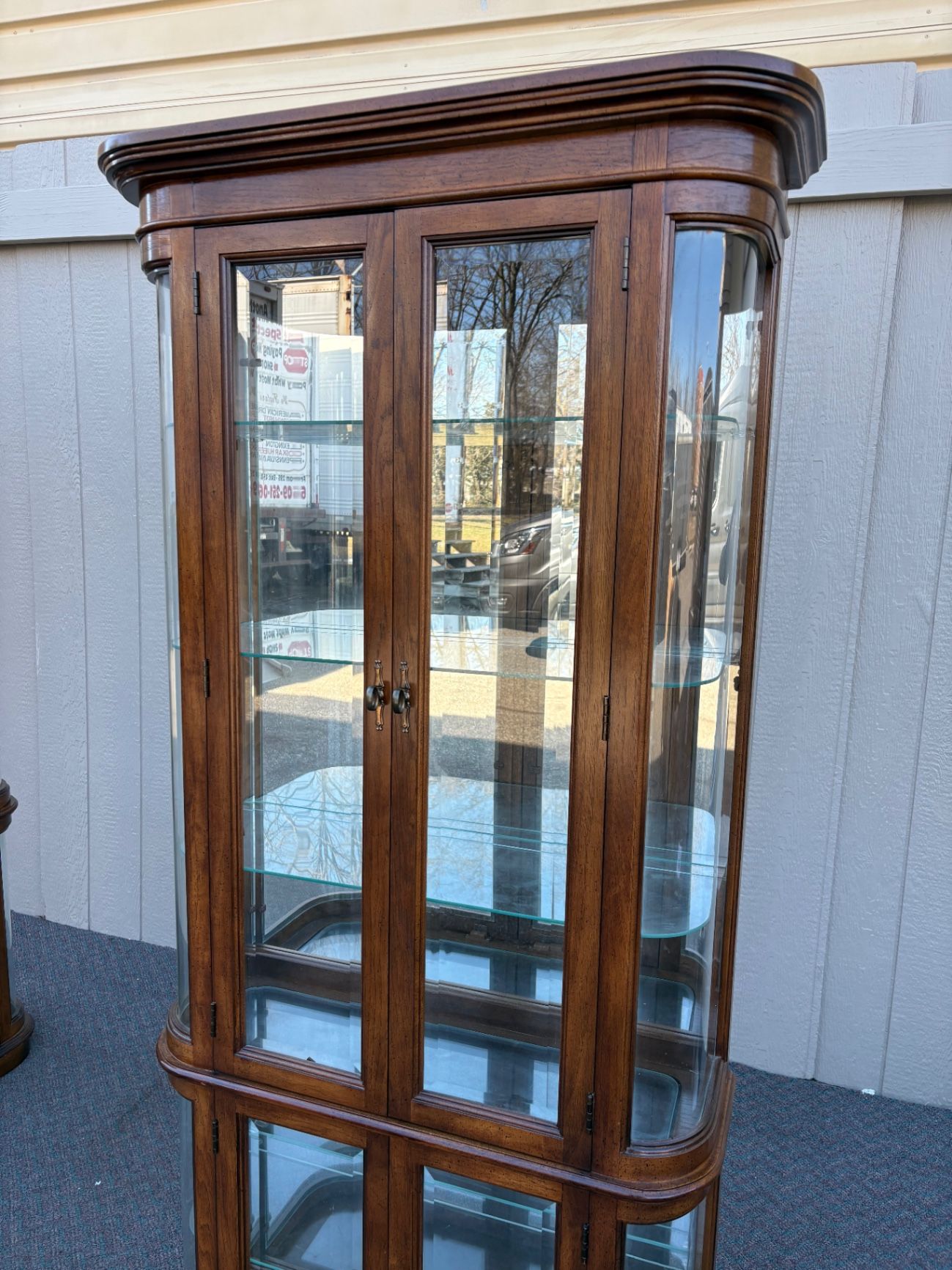 67589  Pulaski Lighted Curio Cabinet with Bowed Glass Doors