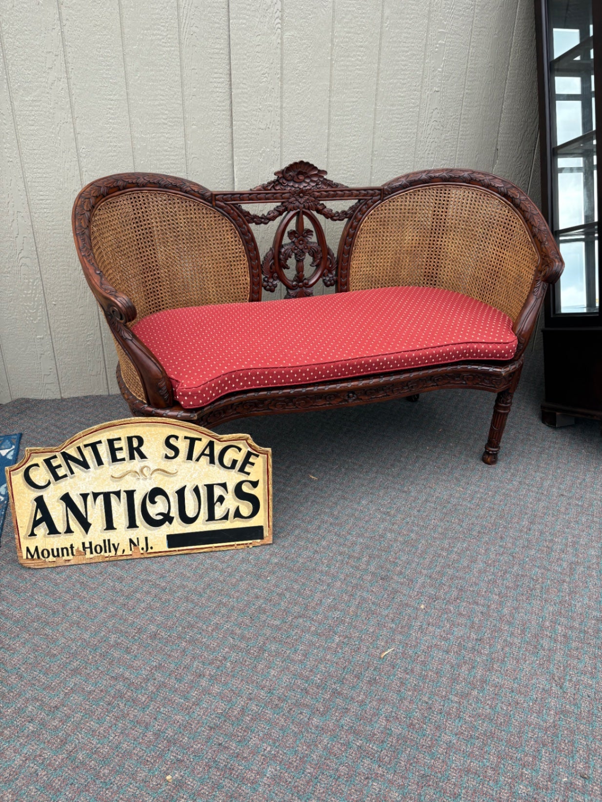 Victorian Carved Wood Settee with Caned Back and Red Cushion