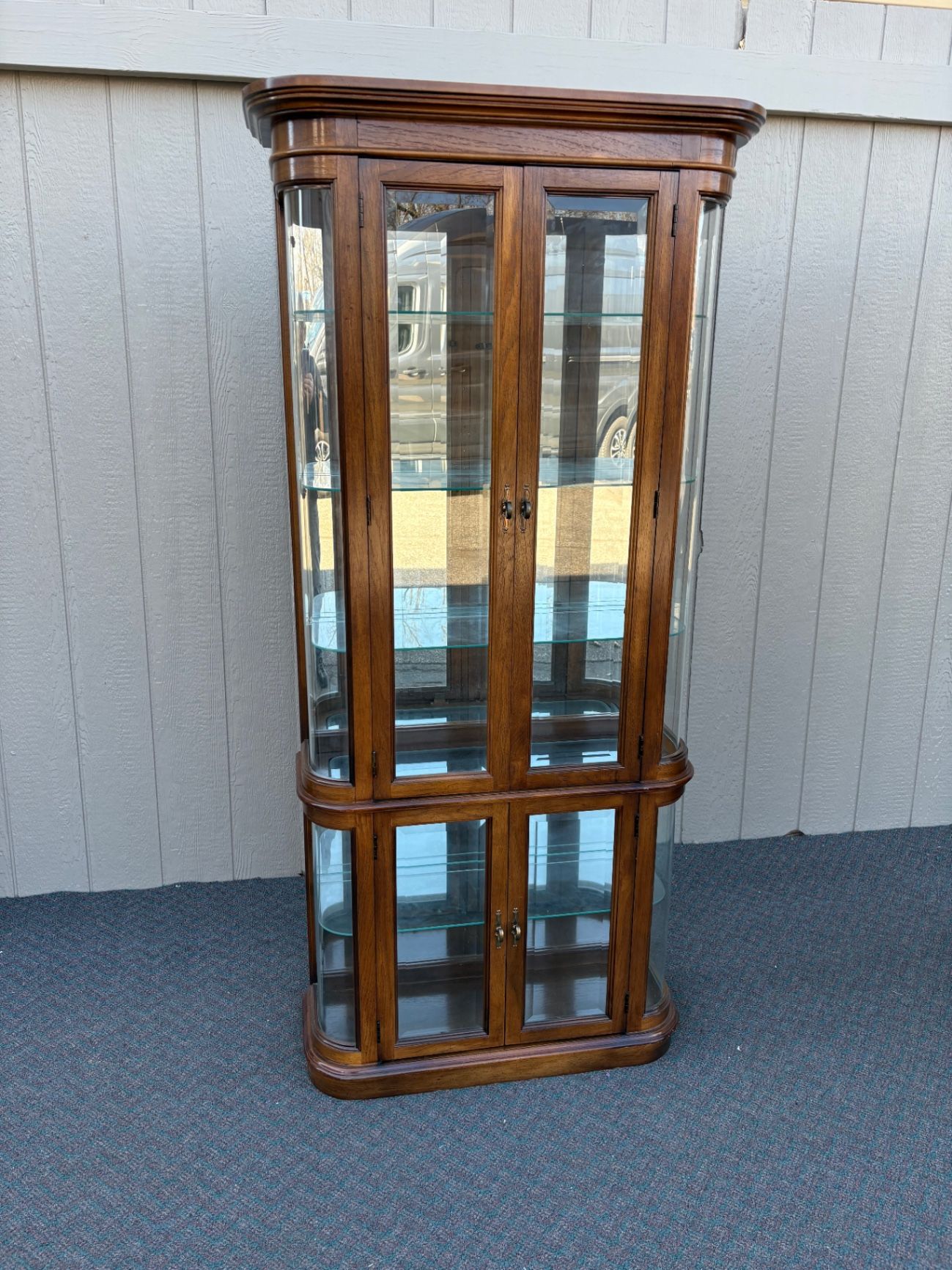 67590 Pulaski Lighted Curio Cabinet with Bowed Glass Doors