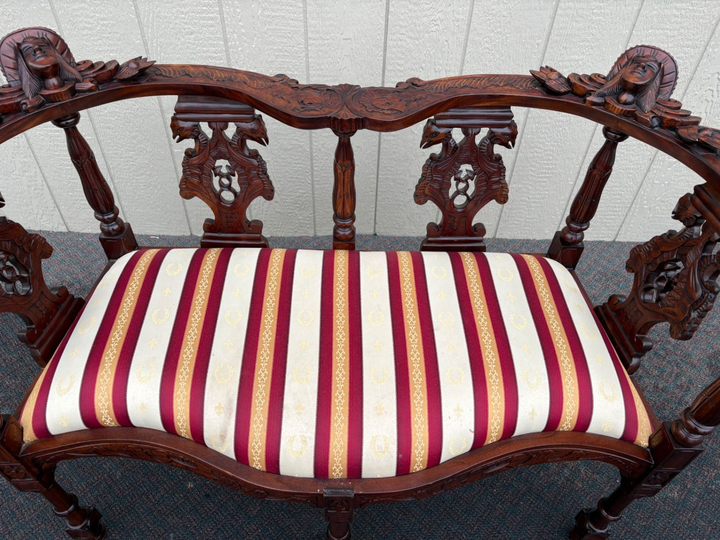 67469  Victorian  Style Carved Mahogany Settee with Figural Details and Upholstery