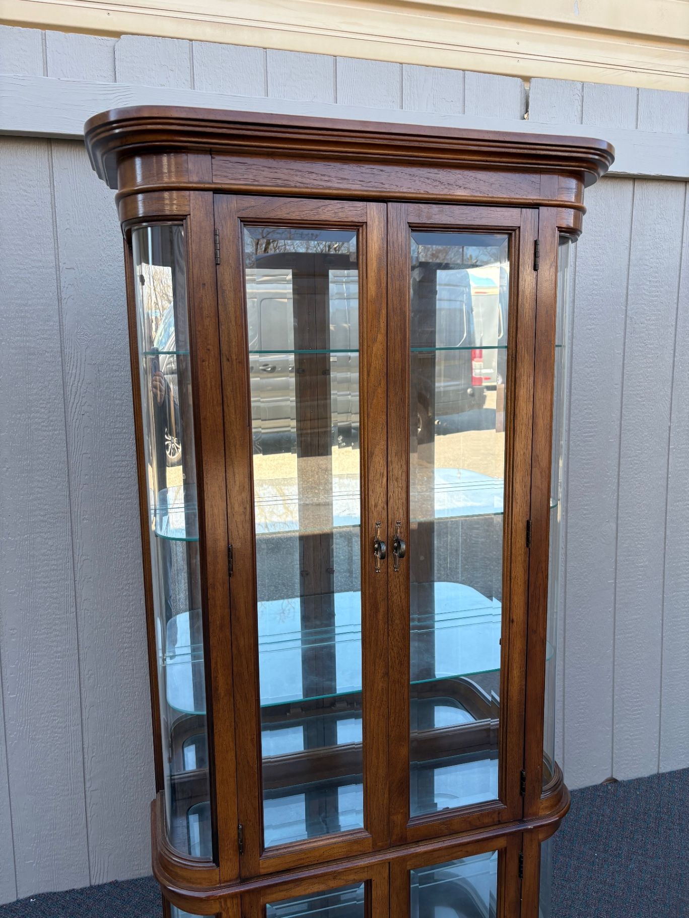 67590 Pulaski Lighted Curio Cabinet with Bowed Glass Doors