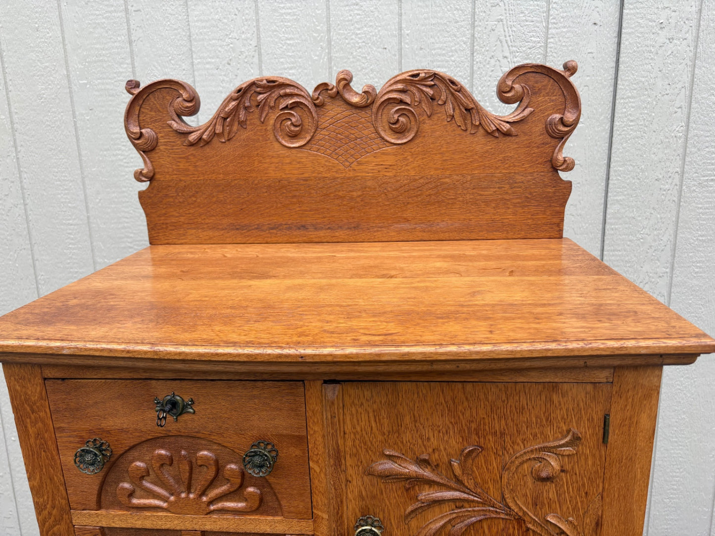 68057  Antique Oak Bonnet Chest with Ornate Carvings and Brass Hardware