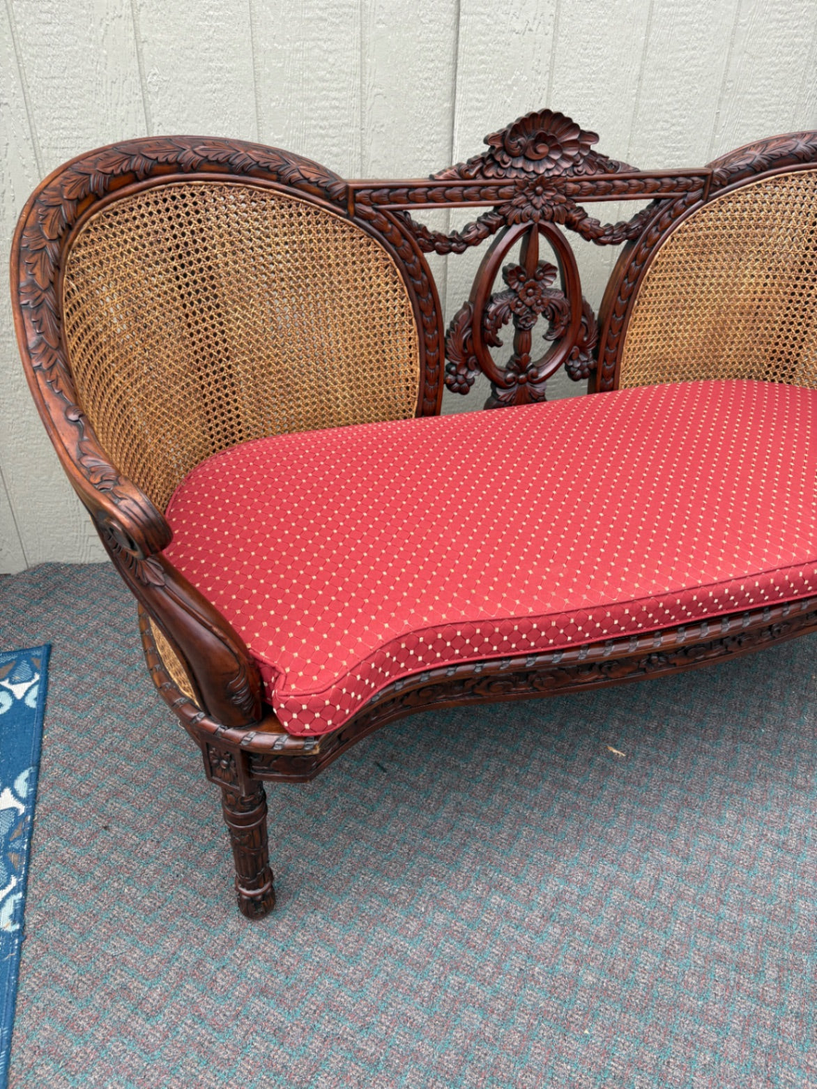 Victorian Carved Wood Settee with Caned Back and Red Cushion