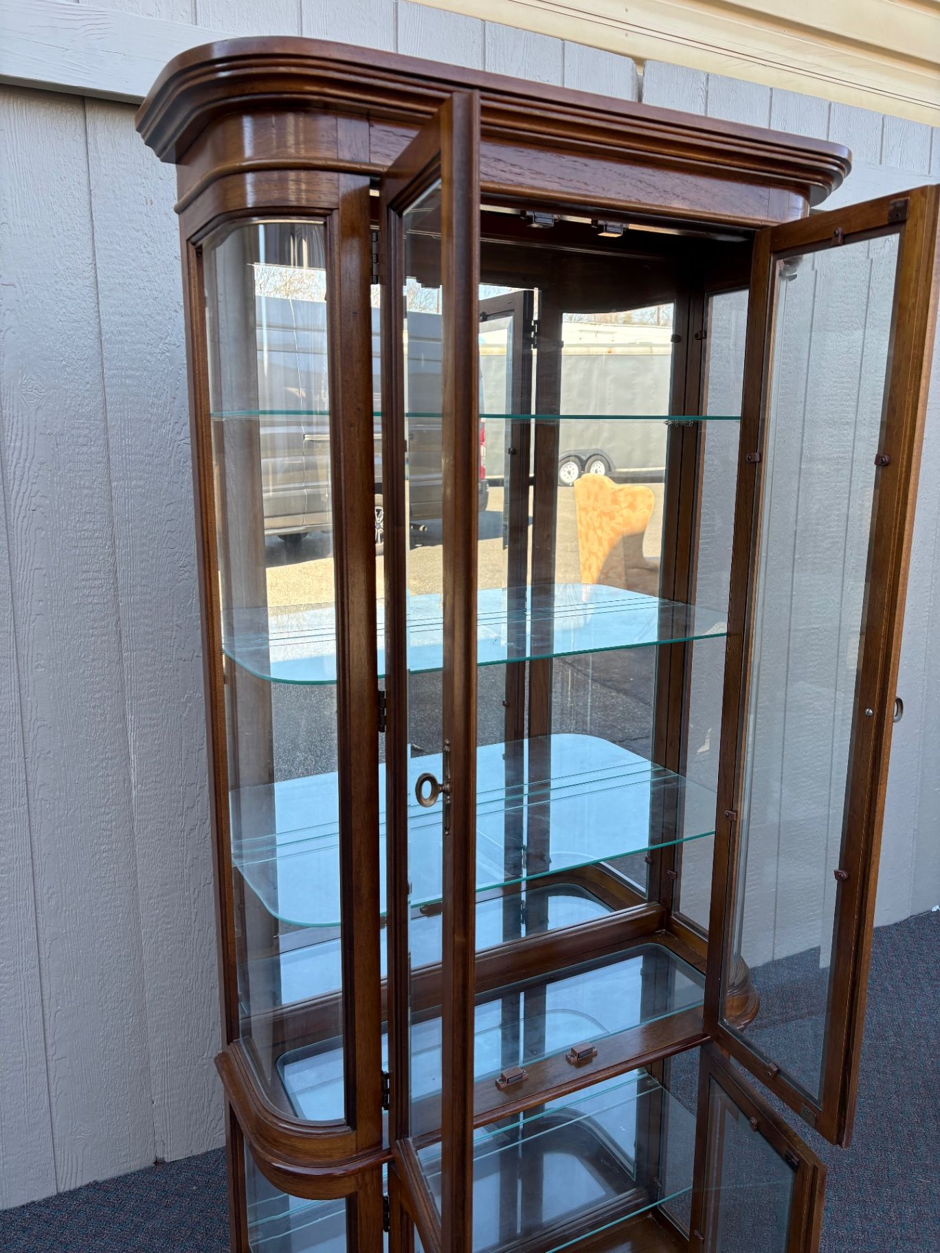 67590 Pulaski Lighted Curio Cabinet with Bowed Glass Doors